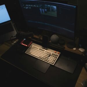 A computer desk with two monitors and a keyboard